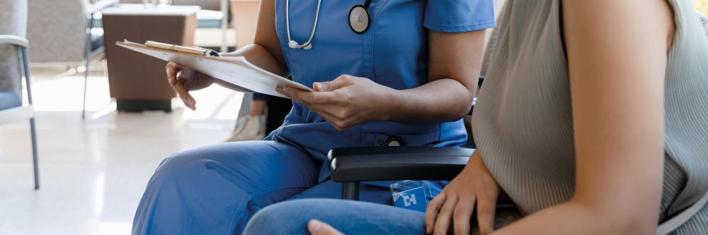 Two people sat in a medical setting